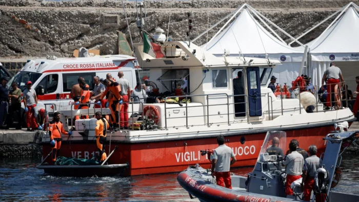 Rescuers bring the final body to shore in Porticello